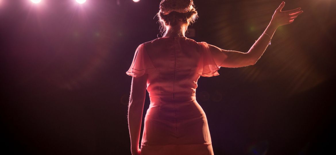 performer-on-stage-in-theater-lights